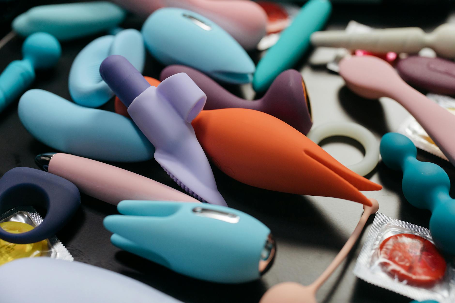 Woman holding colorful vibrators exploring pleasure and sensation