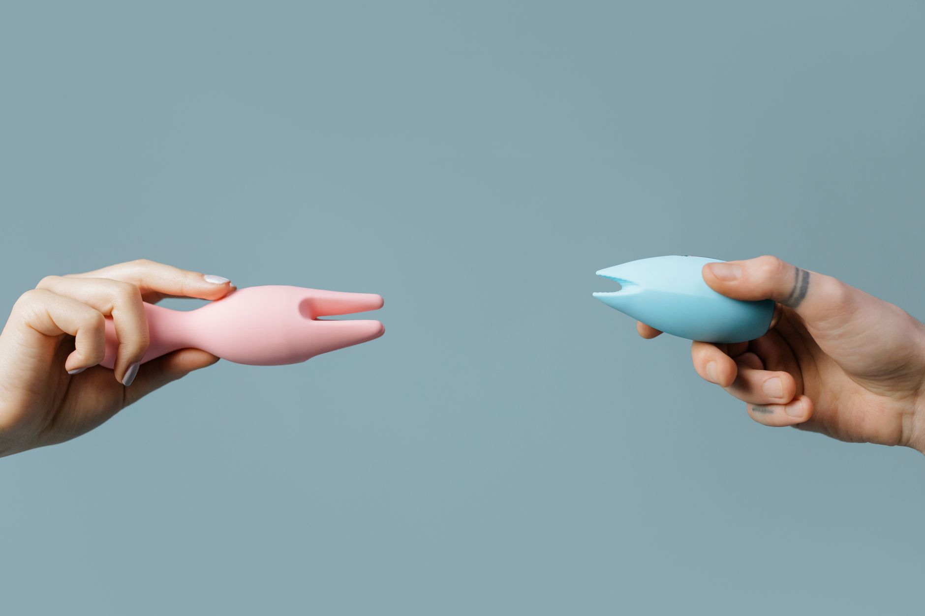 Hands holding vibrators, symbolizing sexual confidence and self-care